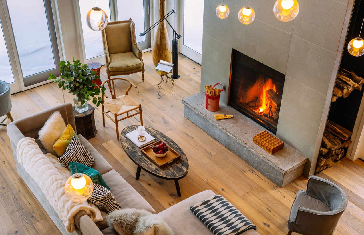 A cottage home interior with a fireplace showing cozy details from different furniture and fixtures.